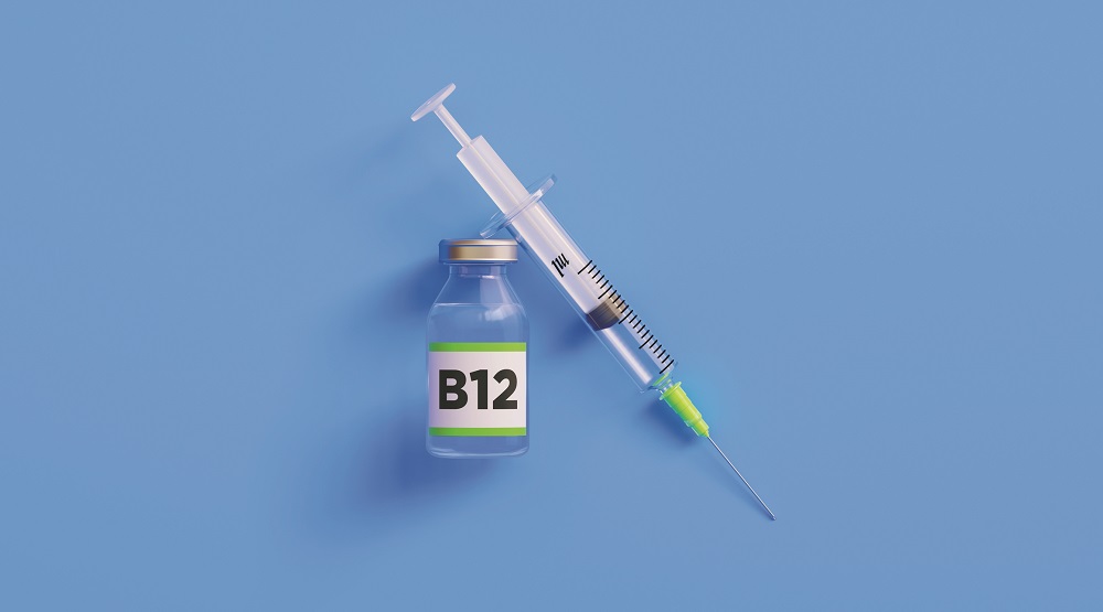 Injectable B12 Vitamin  and Syringe on Blue Background