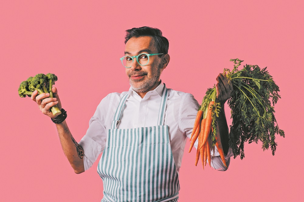 Portrait of a happy cook with vegetables