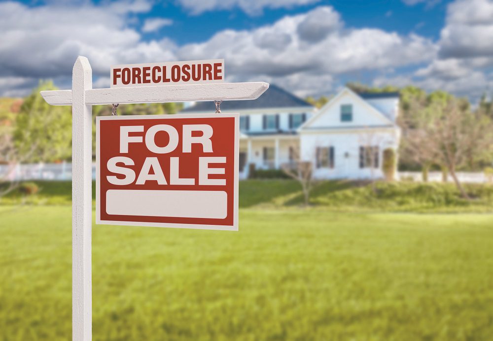 Foreclosure Home For Sale Sign in Front of Large House