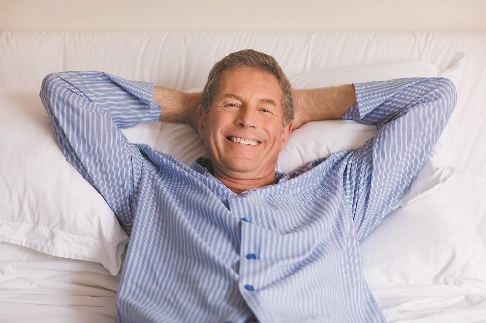 Portrait of a senior man lying in bed
