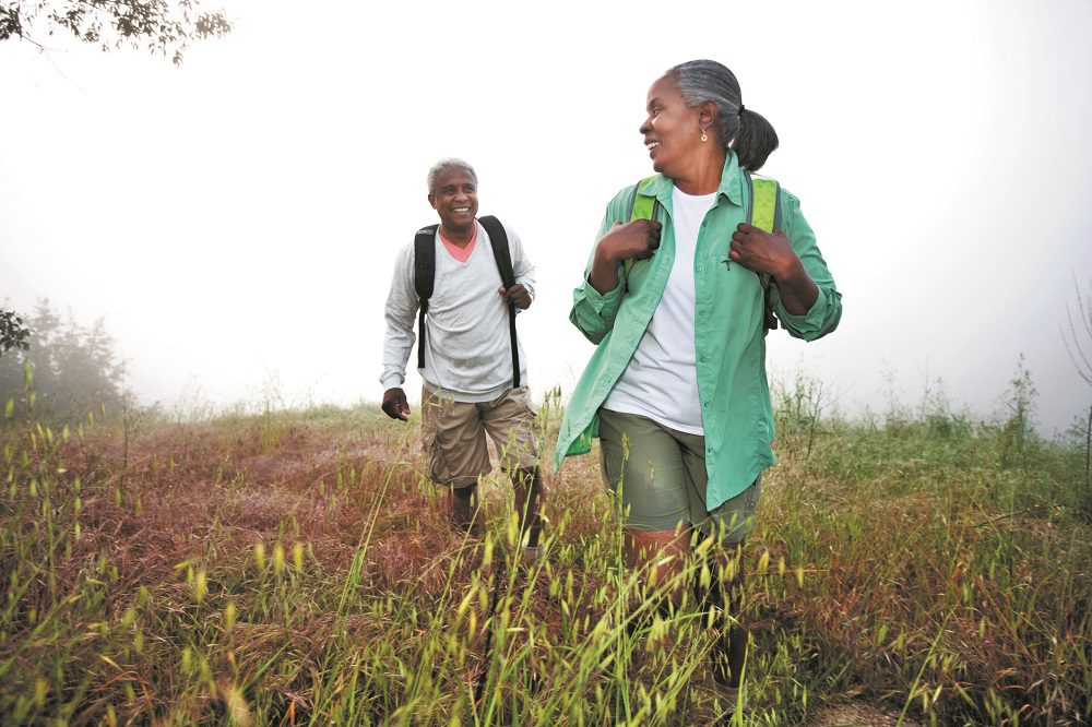 Middle-aged couple hiking in park
