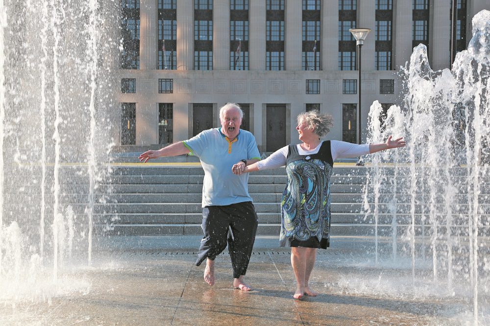 mature couple dance in fountains