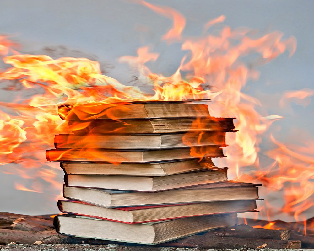 stack of hardcover burning books