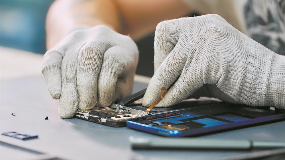 Close-Up Of Hands Working On Table