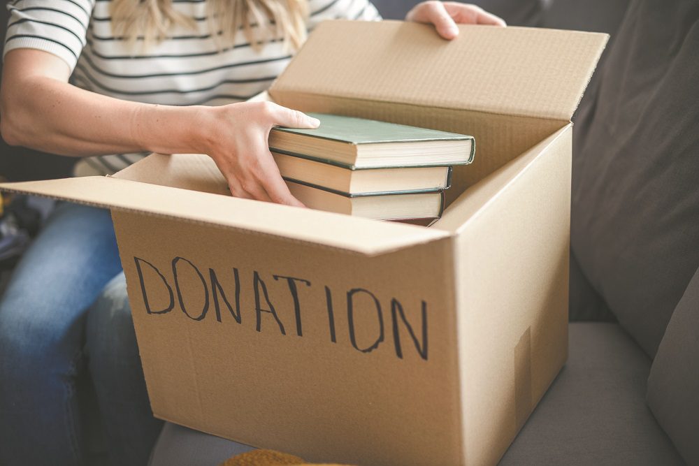 woman puts donations in a box