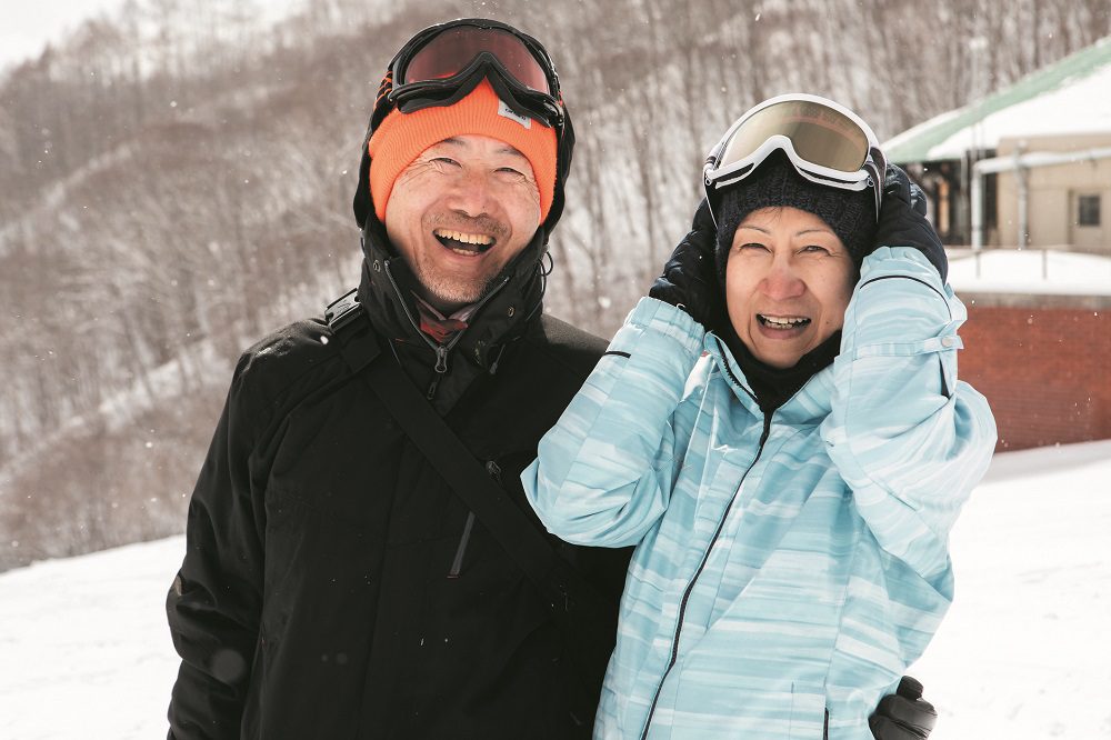 Senior male and female portraits taken on the ski slopes