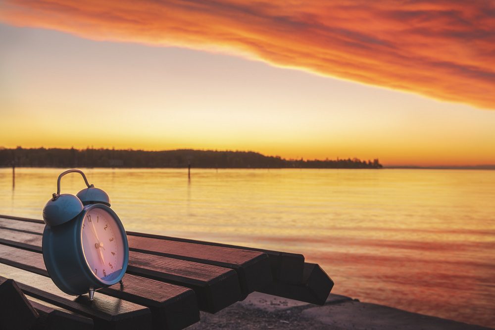 Alarm Clock And Sunrise Over Lake Constance