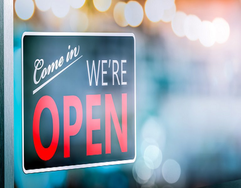 "Come In We're Open" Sign Hanging On Window