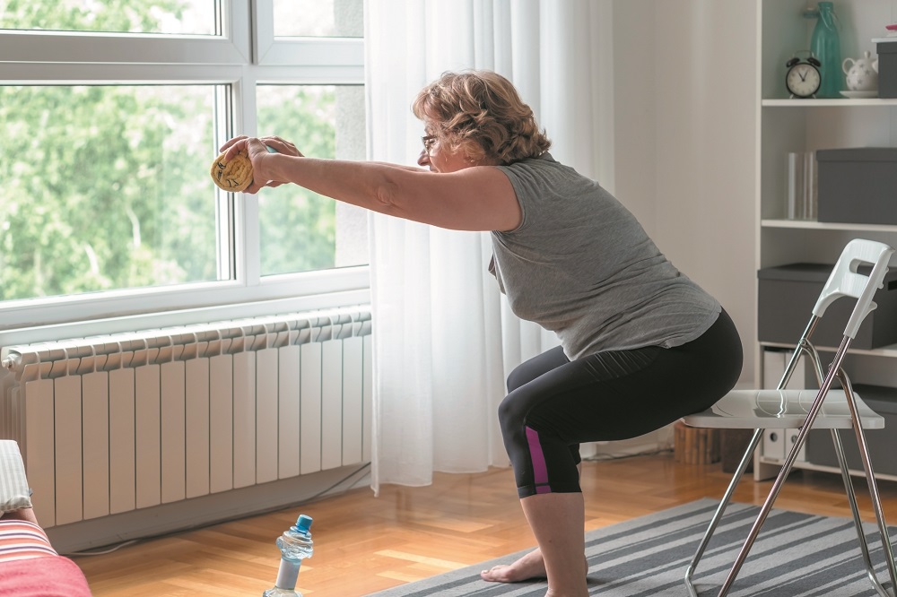 Senior women exercise at home