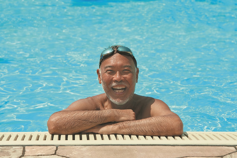 Smiling Senior Man on the rooftop pool