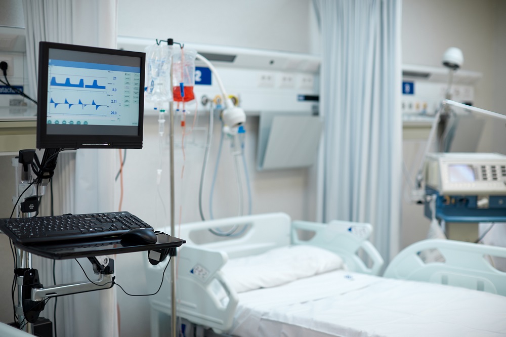 Hospital COVID ward with a medical ventilator's monitor