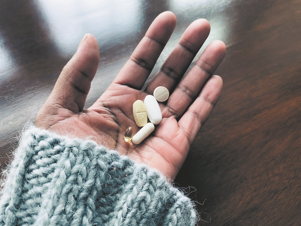 Woman Holds Nutritional Supplements
