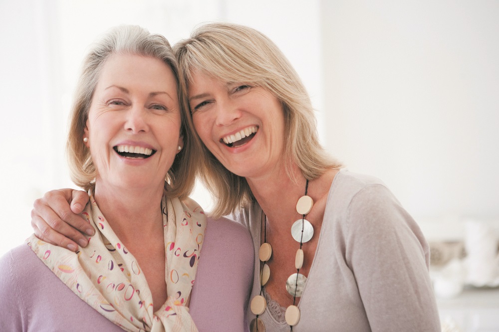 Smiling sisters hugging