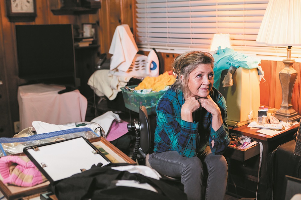 Senior woman at home, messy room