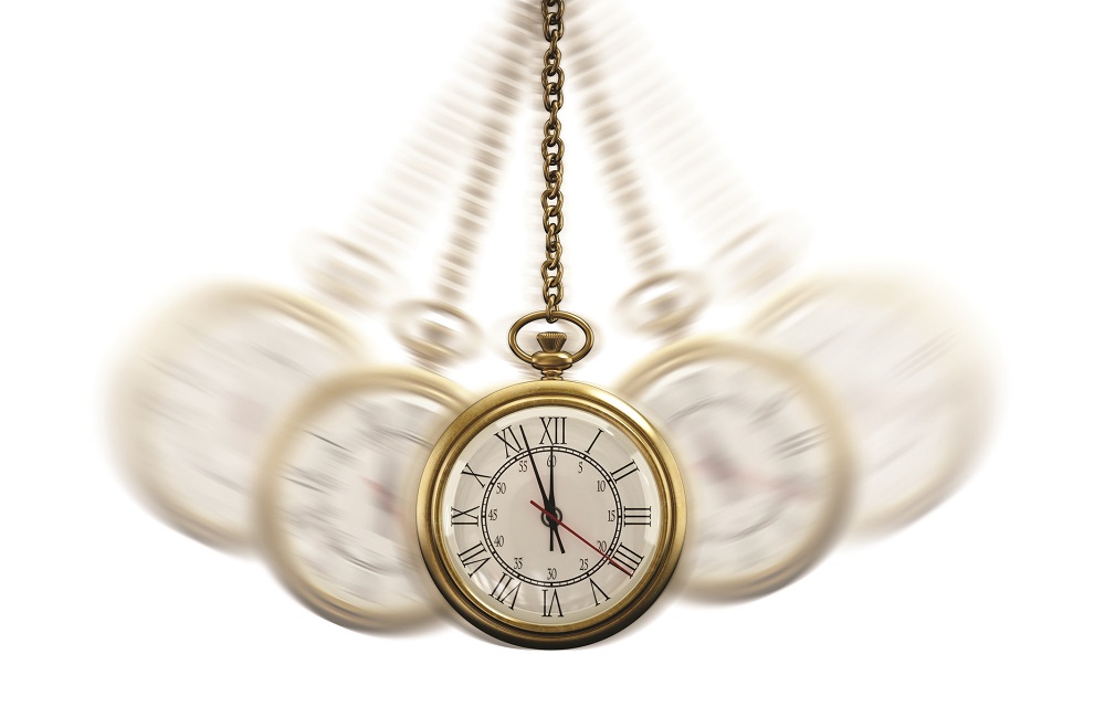 Gold Pocket watch swinging hypnotically from chain. White background. Hypnotism concept