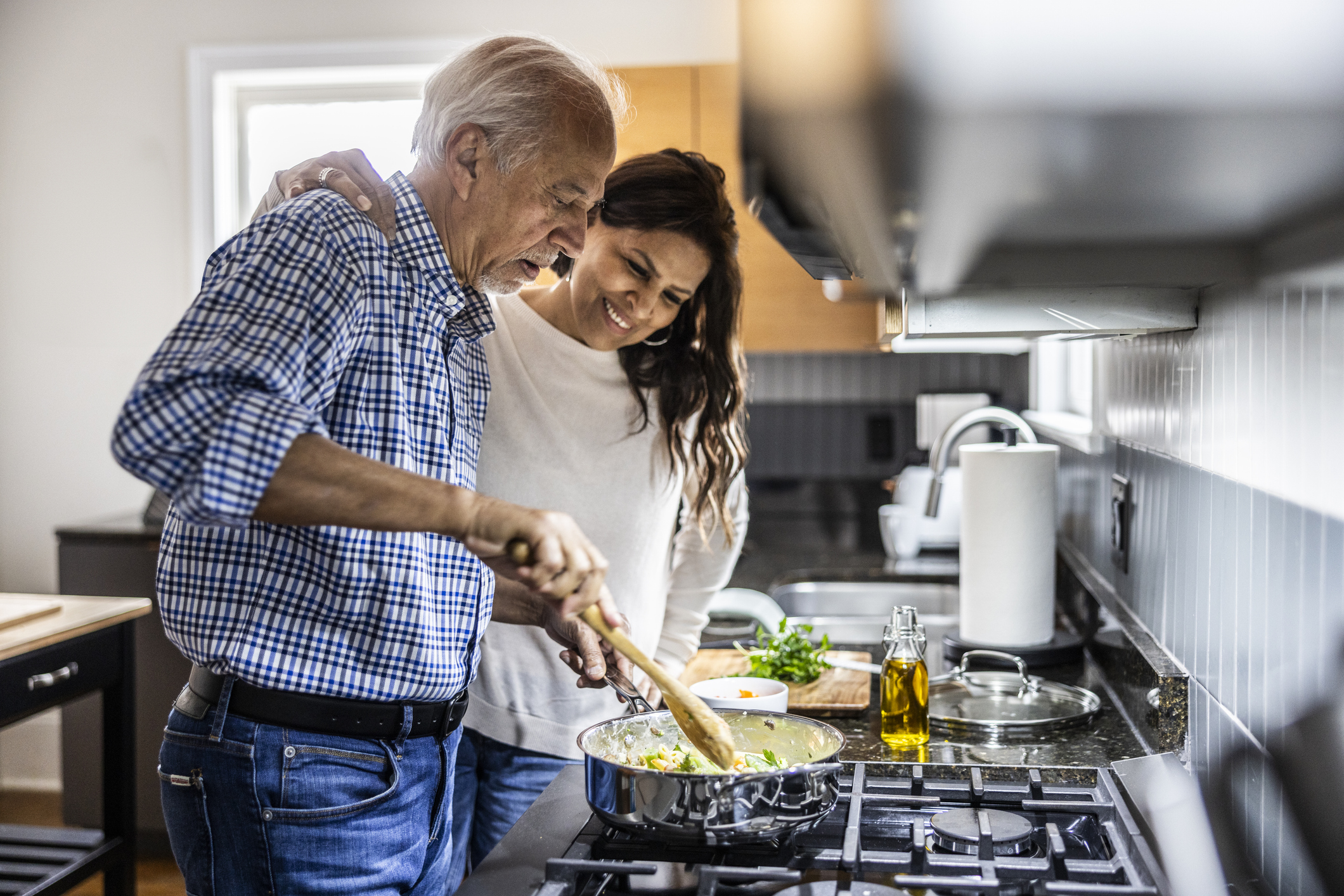 Senior couple cooking in kitchen