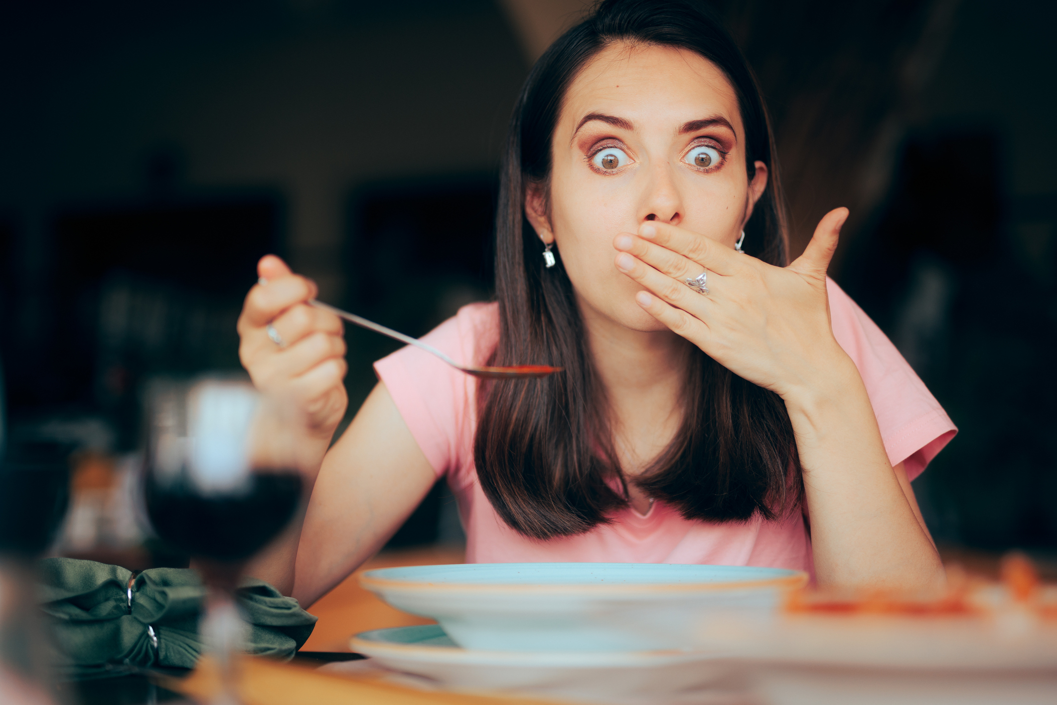 Sick Woman Eating Soup in a Restaurant Feeling Nauseated