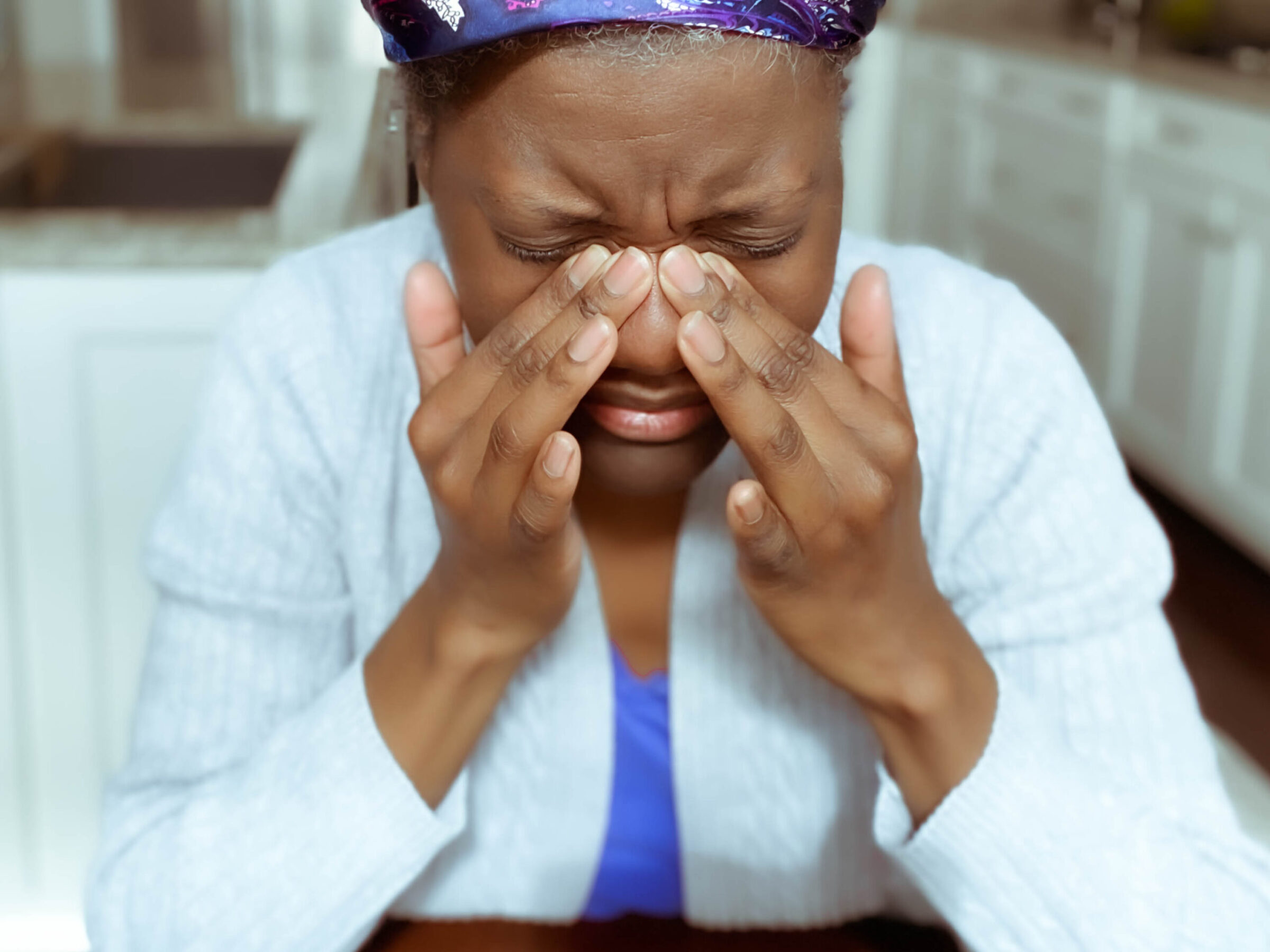 Woman with Sinus Pain Presses Nose